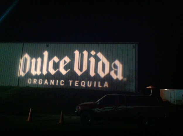 Now that's a way to welcome your guests! A huge logo projected on the side of a warehouse.